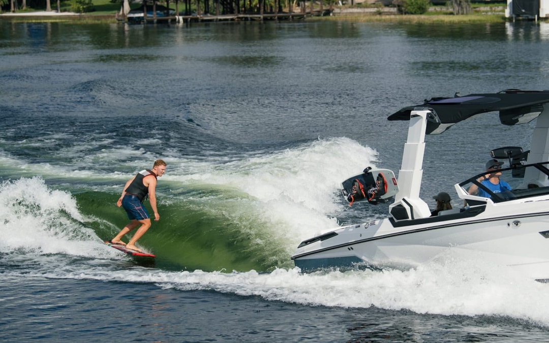 Wakeboarder on wave generated by wakeboat-Boats-Nautique